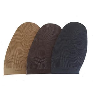 May include: Three shoe sole replacement pads in tan, brown, and black. Each pad features a textured, grid-like pattern across the surface and a smooth bottom edge. The tan pad is labeled WALKLINE, while the black pad is labeled with the number 3.