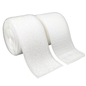 May include: Two rolls of white hook and loop tape, also known as Velcro, are displayed against a white background. The tape is rolled up, showing the texture of the material. The hook and loop tape is a common fastener used in various applications.