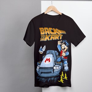 May include: Black t-shirt with a graphic of Mario in a go-kart, with the text "Back to the Kart" in gold lettering.