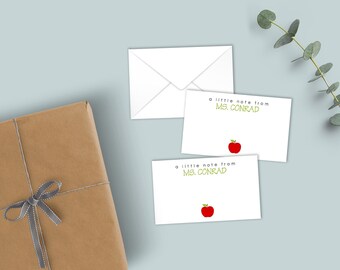 May include: Two white rectangular note cards and one white envelope. Each card features the black text "a little note from" above the green text "MS. CONRAD" and a small red apple illustration at the bottom center of the card.