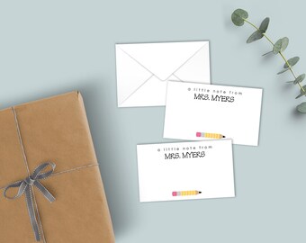 May include: Two white rectangular note cards and one white envelope. Each card features the black printed text 'a little note from MRS. MYERS' and a small yellow pencil graphic at the bottom. A brown gift box with a grey ribbon is also present.