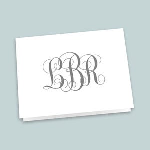 May include: A white folded note card featuring a centered, decorative gray monogram with the letters LBR in a cursive, swirling script font. The card is rectangular and displays the letters in a large, ornate, and interconnected calligraphic style.