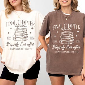 May include: Ivory and espresso-colored t-shirts with the text "FINAL CHAPTER before the..." and "Happily Ever After" printed on them. The design includes a stack of books, stars, and the year 2026. The shirts are part of a bachelorette collection.