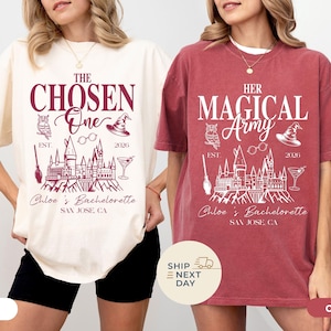 May include: Two oversized t-shirts, one ivory and one crimson, featuring a graphic design. The ivory shirt reads "The Chosen One" with a Hogwarts castle illustration. The crimson shirt says "Her Magical Army". Both shirts have "Chloe's Bachelorette, San Jose, CA".
