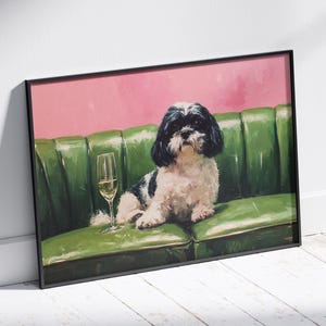 May include: A framed art print featuring a Shih Tzu dog with black and white fur, lounging on a green sofa. A glass of white wine sits beside the dog. The background is pink.