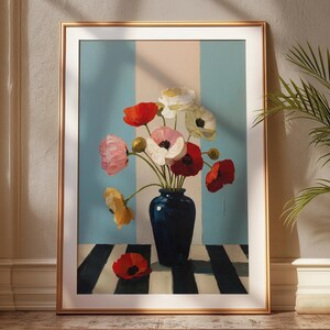 May include: Framed art print featuring a still life of poppies in a dark blue vase. The painting has a gold frame and a background with blue and white stripes. The poppies are red, pink, white, and yellow. The painting is on a black and white striped surface.