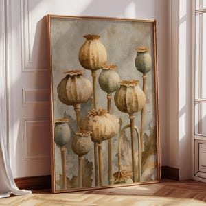 May include: A framed art print featuring a botanical illustration of dried poppy seed heads in shades of beige, brown, and green. The artwork has a vintage aesthetic and is displayed in a room with hardwood floors and a window.