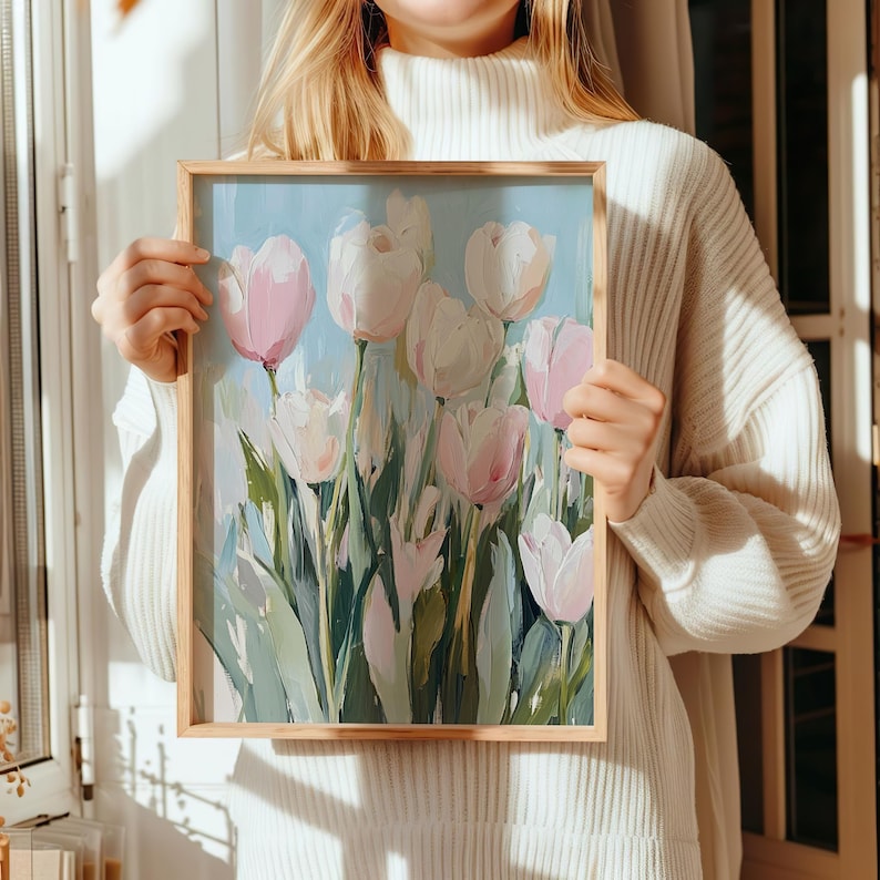 May include: A framed painting of a bouquet of pink and white tulips with green stems and leaves against a light blue background.