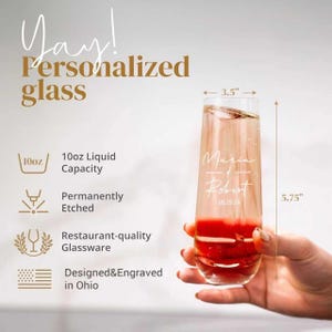 May include: A personalized champagne flute with the names Maria and Robert and the date 05.15.24 etched on the glass. The glass is 5.75 inches tall and 3.5 inches wide, with a 10oz liquid capacity. The text "Yay! Personalized glass" is at the top.