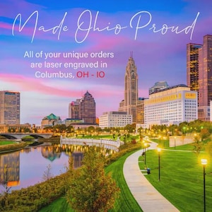 May include: Scenic image of Columbus, Ohio, with text reading "Made Ohio Proud." The text also states that unique orders are laser engraved in Columbus, OH. The image features a river, buildings, and a walking path.