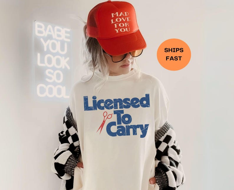 "Licensed to Carry" Hairdresser Shirt. 

Looking for the perfect gift for the hair magician in your life? Whether it’s a birthday gift, graduation gift, or just because they slay with scissors, this bold hairstylist shirt is equal parts stylish and hilarious. Designed for comfort and daily wear, it’s a subtle nod to salon life that every hairdresser, hair stylist, or stylist-in-training will appreciate.