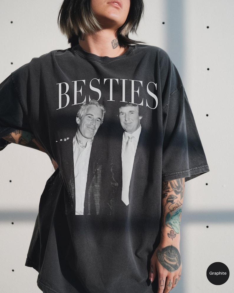 May include: Graphite-coloured t-shirt featuring the word "BESTIES" in white above a black and white image of two men. The shirt has a relaxed fit.