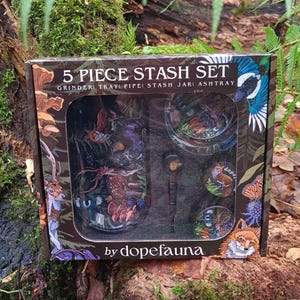 May include: A 5-piece stash set in a decorative box. The box features illustrations of wildlife and the text "5 PIECE STASH SET". The set includes a grinder, tray, pipe, stash jar, and ashtray. The brand name "dopefauna" is also visible.