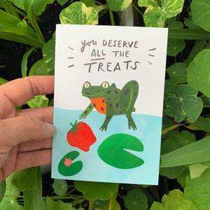 You deserve all the treats! - Happy frog and strawberry illustrated A6 Greetings card, well done and congratulations