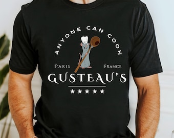 May include: Black t-shirt with a cartoon rat chef holding a wooden spoon. The text "Anyone can cook" is in a circle around the rat. The text "Paris" and "France" are above and below the text "Gusteau's" with five stars below.
