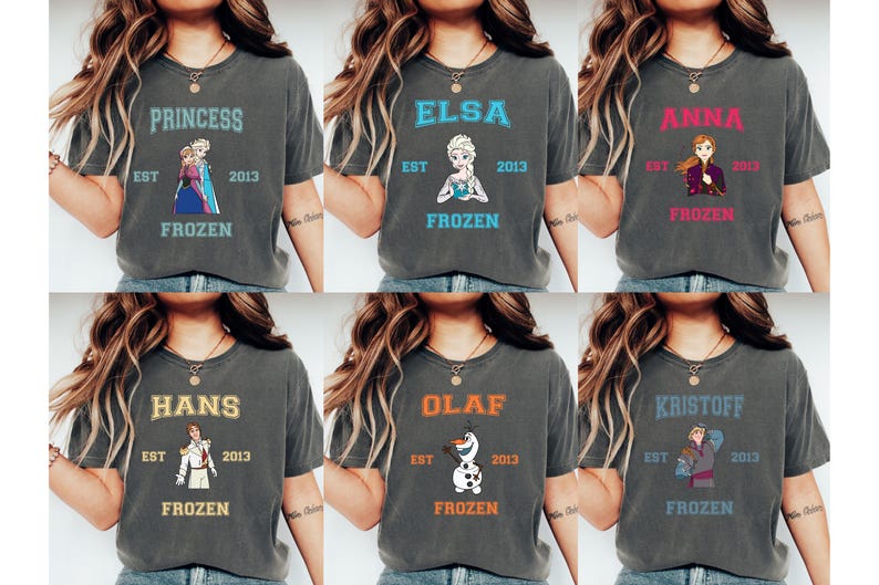 May include: Six gray t-shirts with different Frozen characters printed on them. Each shirt has the text "EST 2013 FROZEN" printed below the character. The characters are Princess, Elsa, Anna, Hans, Olaf, and Kristoff.