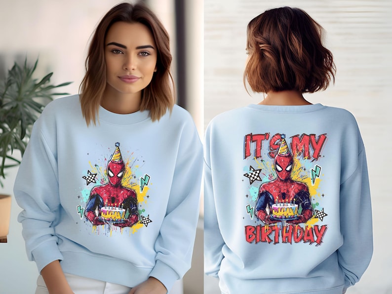 A woman wearing a light blue sweater with a Spider-Man graphic and the text "It's my birthday" printed on the back.