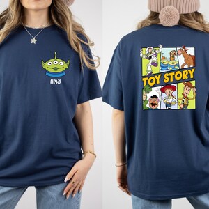 a woman wearing a navy blue t-shirt with a graphic of a character from the Toy Story movie.