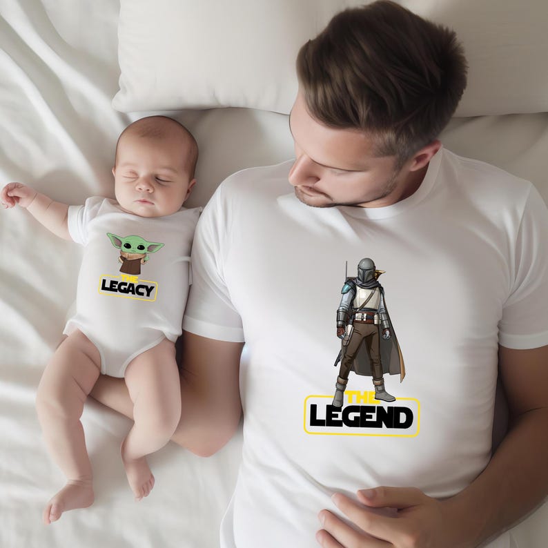 a man is holding a baby wearing a star wars shirt