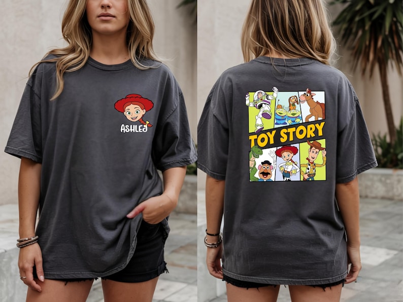 A woman wearing a gray t-shirt with a graphic of characters from the Toy Story movie on the back.