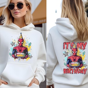 A woman wearing a white hoodie with a Spider-Man graphic and the text "It's my birthday" printed on the back.