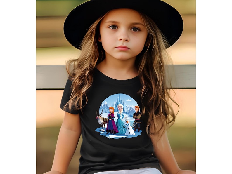 May include: A black t-shirt with a colorful graphic of the characters from the movie Frozen. The graphic features Elsa, Anna, Kristoff, Olaf, and Sven in front of the ice castle.