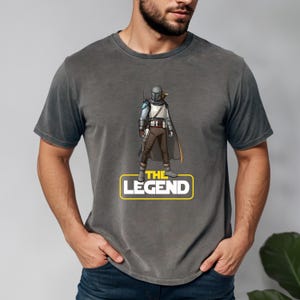 a man wearing a star wars t - shirt that says the legend