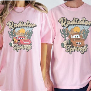 a man and a woman wearing pink shirts