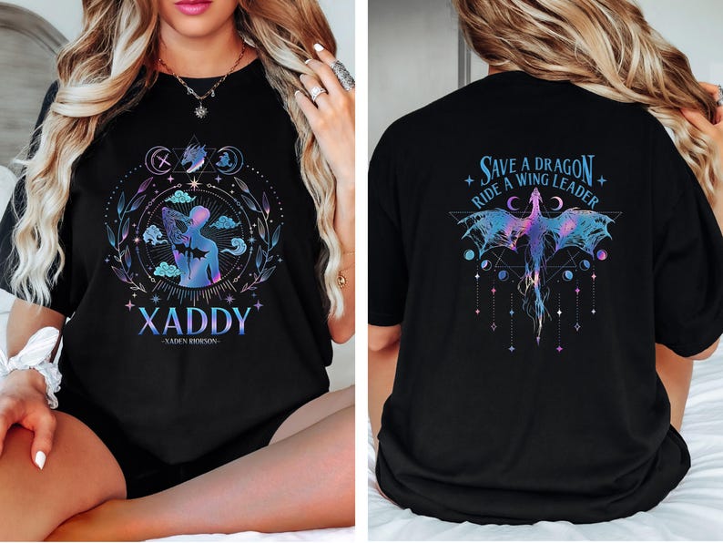 May include: Black t-shirt with a graphic design featuring a person with wings and the text "XADDY - LAUREN ROBINSON" on the front. The back of the shirt features a dragon with the text "Save a Dragon Ride a Wing Leader".