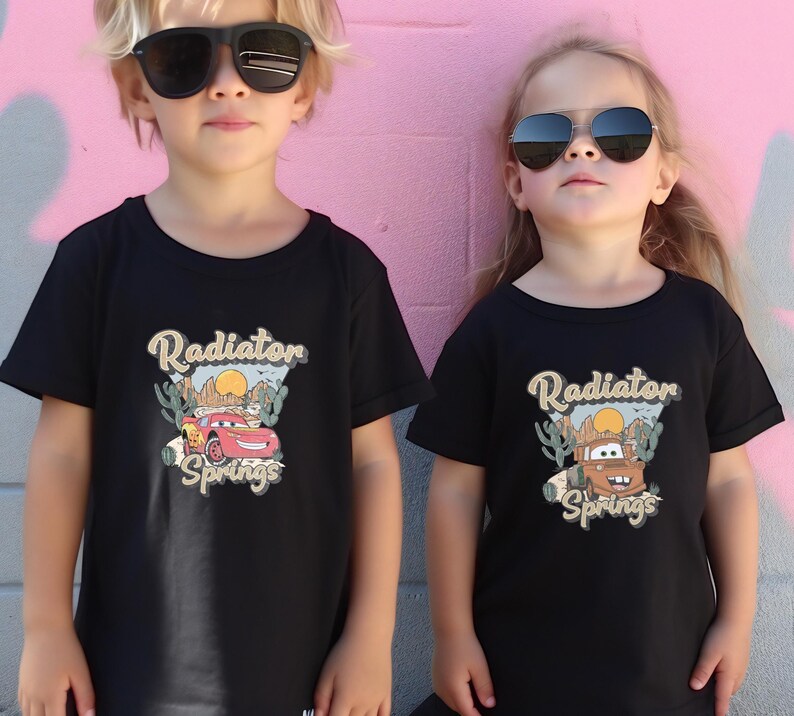 two little girls wearing sunglasses standing next to a pink wall