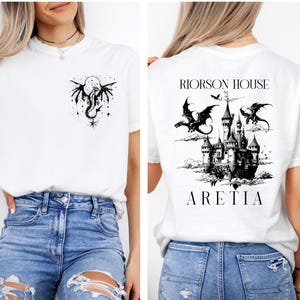 May include: White t-shirt with a black dragon and moon graphic on the front. The back of the shirt features a castle design with dragons and the text "RIORSON HOUSE ARETIA".