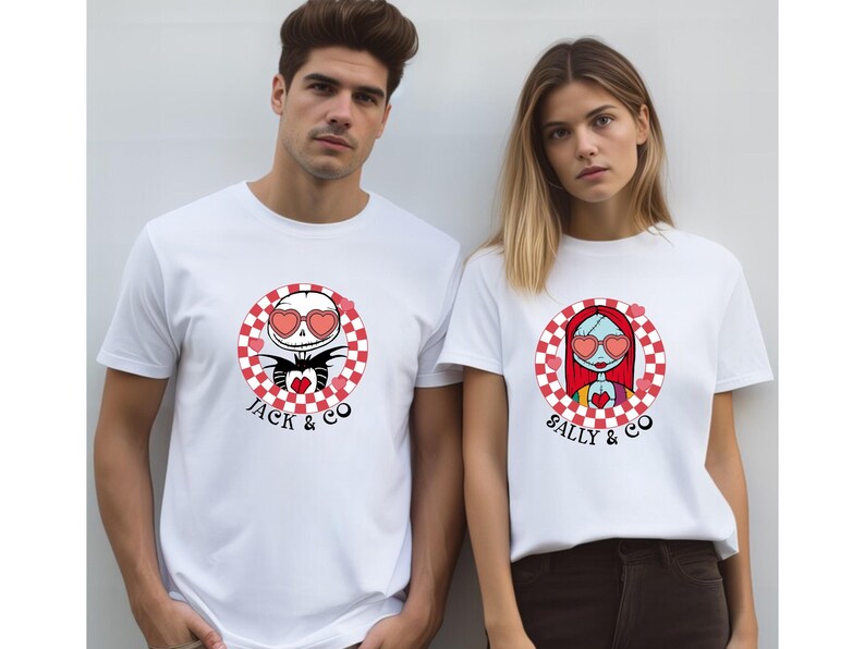 May include: Two white t-shirts with a chequered circle design featuring Jack and Sally from The Nightmare Before Christmas. Jack is wearing heart-shaped sunglasses and holding a red heart. Sally is wearing heart-shaped sunglasses and has red hair. The text "Jack & Co" is below Jack's image and "Sally & Co" is below Sally's image.