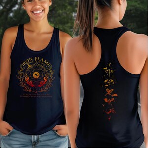 A woman wearing a black tank top with a graphic design on the front and back.