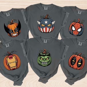 A collection of six t-shirts with Halloween-themed designs, including a superhero mask, a pumpkin, a spider-man, a Hulk, a Deadpool, and a Iron Man.