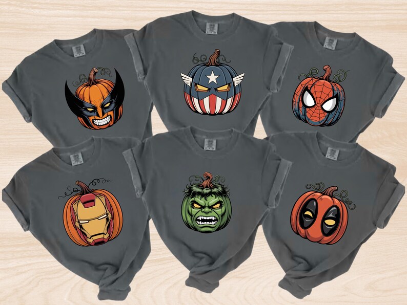 A collection of six t-shirts with Halloween-themed designs, including a superhero mask, a pumpkin, a spider-man, a Hulk, a Deadpool, and a Iron Man.
