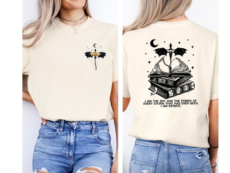 a woman wearing a white t-shirt with a graphic design on the back. The design features a dragon and a crescent moon, along with the text "I am the sky and the power of every storm that ever been, I am infinite".
