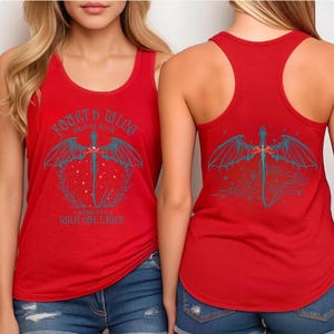 May include: Red tank top with a graphic design featuring a sword with dragon wings and the text "Fourth Wing". The back of the tank top also displays the same design. The tank top is worn with blue denim shorts.