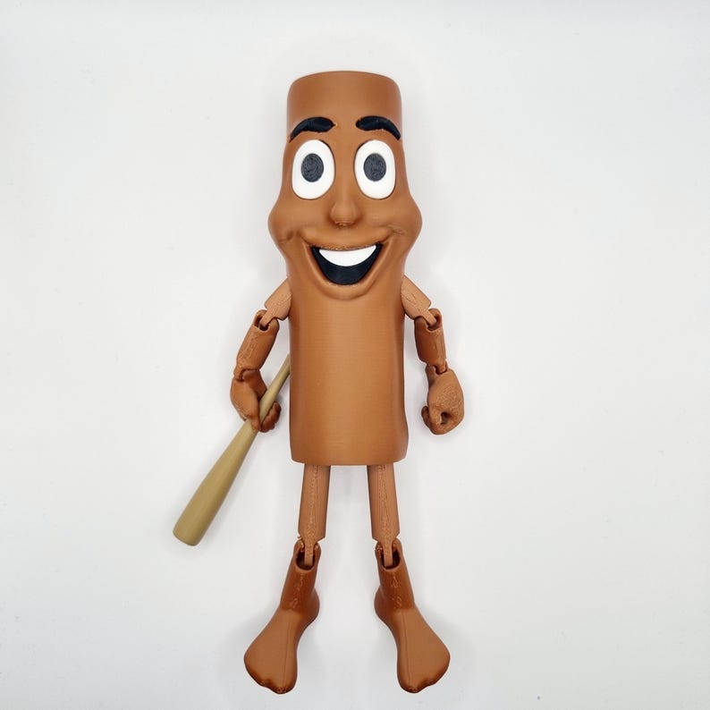 Puede incluir: Una figura de acci&oacute;n articulada marr&oacute;n de un personaje de dibujos animados con una cara sonriente, sosteniendo un bate de b&eacute;isbol de madera. La figura tiene un cuerpo cil&iacute;ndrico y lleva zapatos marrones.