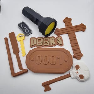 May include: A set of brown and gold escape room props, including a wooden cross, a sign with the number 0001, a key with a skull, a flashlight, and a key with a tag that says 1000. The word "DOORS" is spelled out in gold letters.