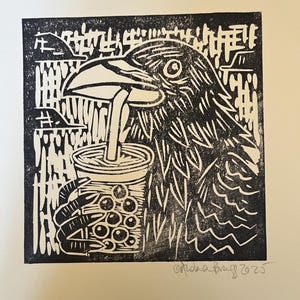 May include: Black and white linocut print of a crow drinking from a bubble tea. The crow's eye is open, and it is holding the cup with its clawed hand. The background features a landscape and the artist's signature.