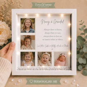 May include: A white square shadow box frame with integrated LED lights containing five photographs of children and printed text that reads Nanny & Grandad, Always there to listen, always there to care, always there to love us, no matter when or where.