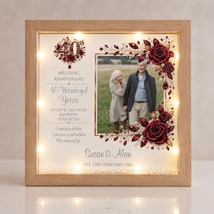 May include: A square wooden shadow box frame with internal LED lights containing a photo of a couple, decorated with deep red roses and gold accents. Text reads: 40th Wedding Anniversary, 40 Wonderful Years, Susan & Alan, EST. 23RD FEBRUARY 1986.