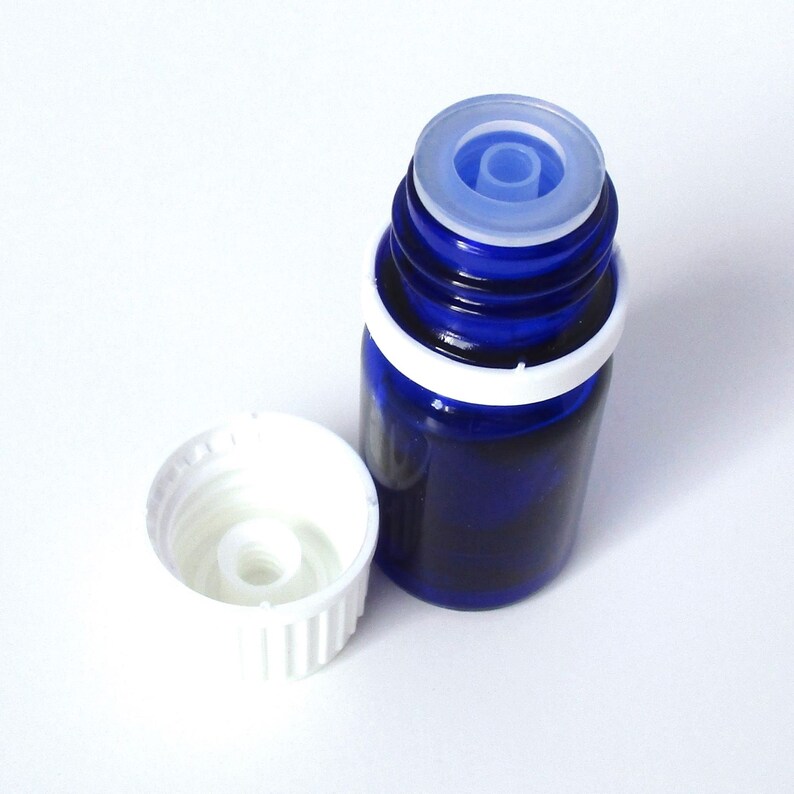 May include: A blue glass bottle with a white cap and a clear dropper. The bottle is partially filled with a dark liquid.