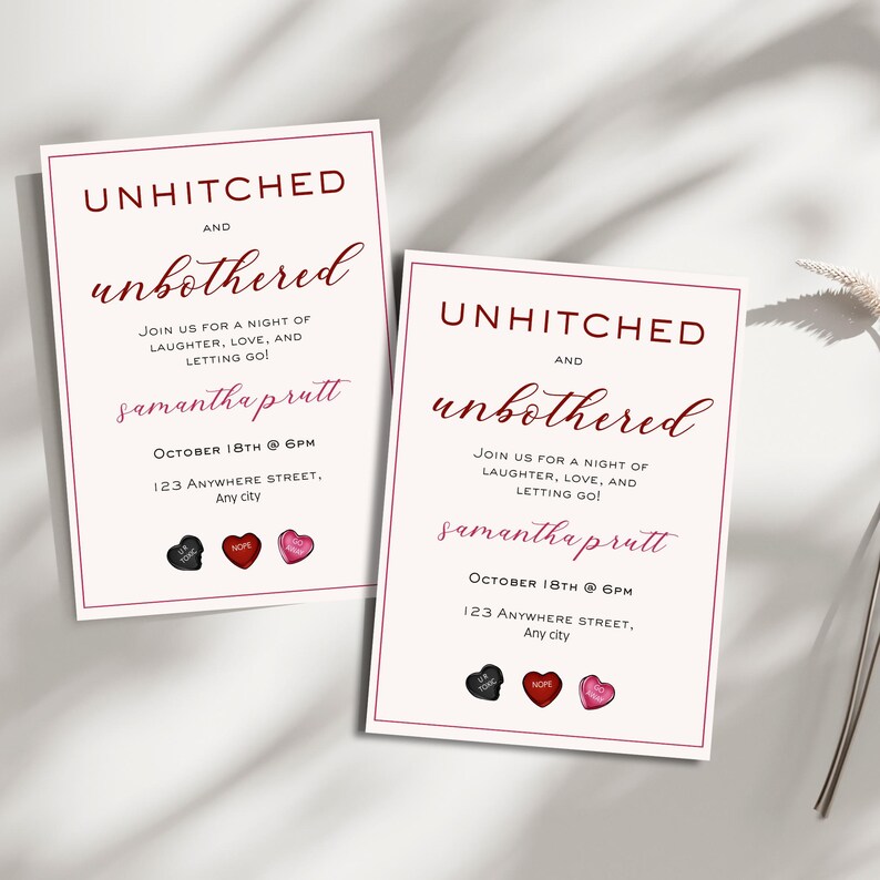 May include: Two white cards with red borders and black text that reads "Unhitched and Unbothered" in a cursive font. The cards also include the text "Samantha prutt" and "October 18th @ 6PM" with the address "123 Anywhere Street, Any city". The cards have three small heart-shaped sweets on them, one black, one red, and one pink.