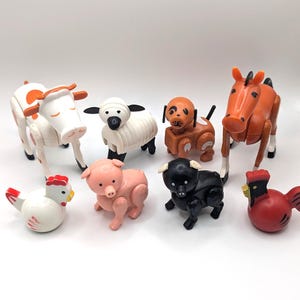 May include: A set of nine vintage plastic farm animal toys. The set includes a cow, sheep, pig, dog, horse, rooster, and two chickens. The toys are all brightly colored and have movable parts.