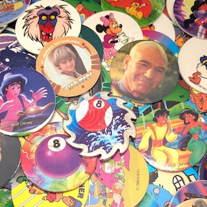 May include: A collection of colorful plastic tokens featuring various characters and images, including Star Wars, Disney, and a pool ball. The tokens are round and have a diameter of approximately 2 inches.