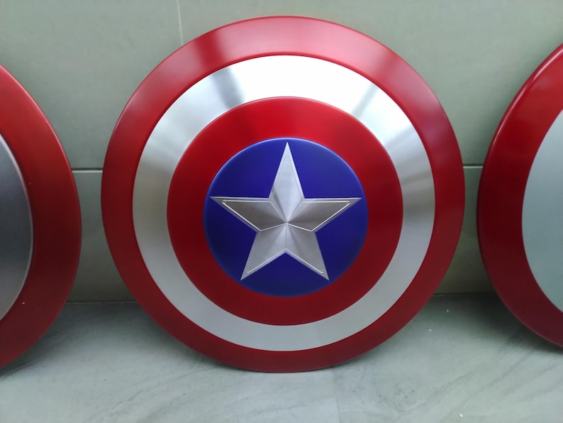 May include: Two red, white, and blue Captain America shields. The shields are round and have a five-pointed star in the center.