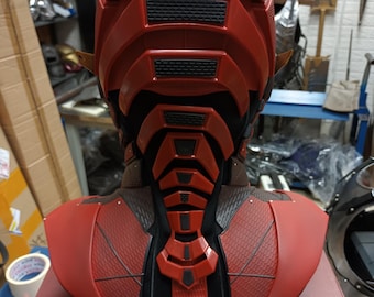 May include: Red and black plastic bust of the Flash superhero. The bust features a detailed helmet with a textured design and a sculpted neck piece. The bust is displayed on a red box.