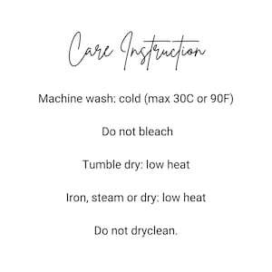 May include: White background with black text detailing care instructions. The text includes: machine wash cold (max 90F), do not bleach, tumble dry low heat, iron steam or dry low heat, and do not dry clean.