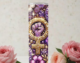 May include: A stainless steel tumbler with a purple, gold, and pink design. The design features a raised fist inside a female symbol, surrounded by flowers and jewels.